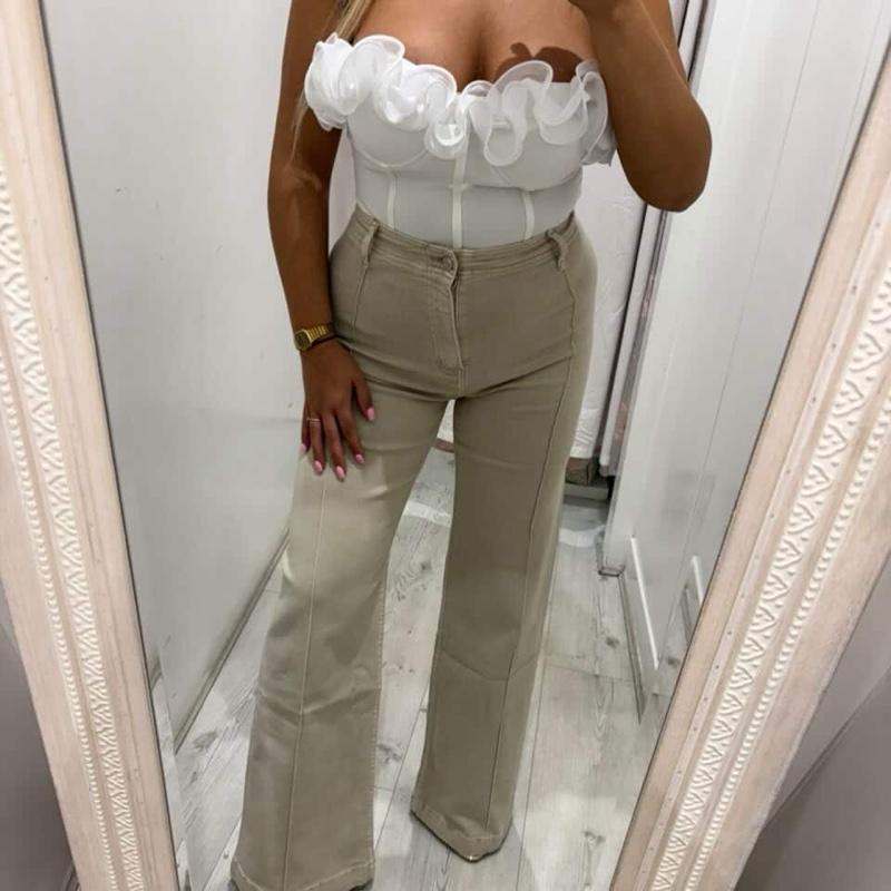 Woman wearing ADA beige jeans with stylish flare and comfortable fit