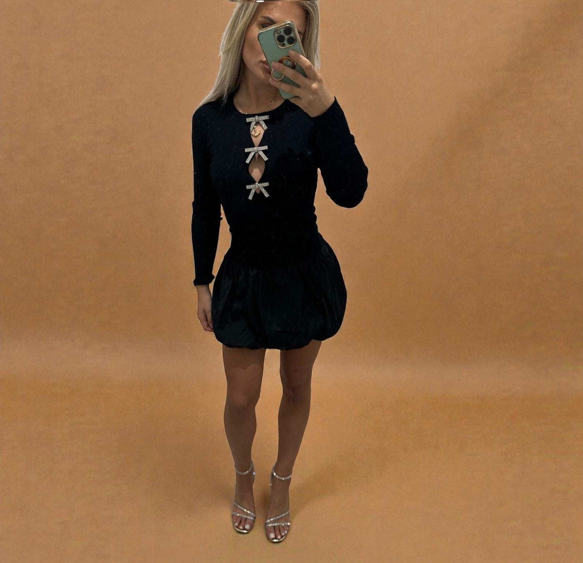 Black ALLEGRA bow puff dress, long sleeves with ruffled hem, women’s casual wear.