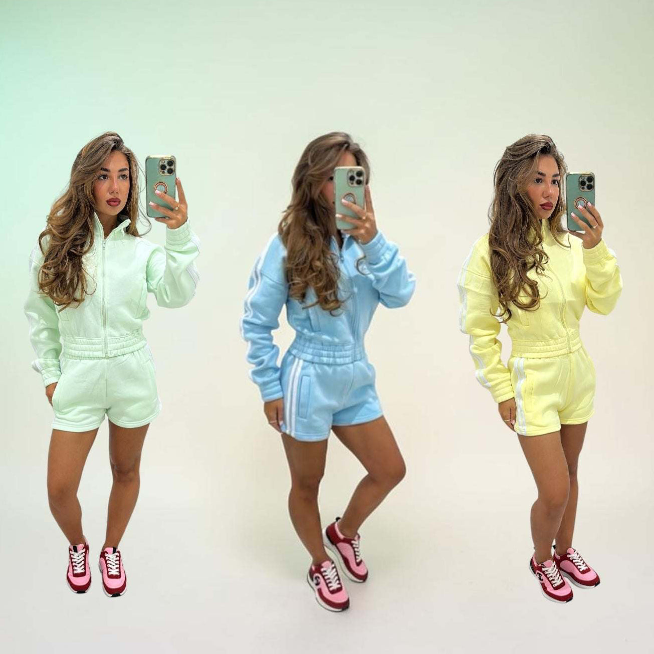 Woman wearing fleeced stripe detail short tracksuit set RIRI sitting on stairs outdoors