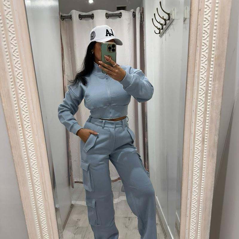 Woman wearing KADIE Zip Up Cropped Top and cargo trouser tracksuit in casual outdoor setting