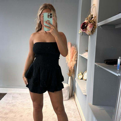Woman wearing Lola Cheesecloth Summer mini playsuit with frilly shorts and bandeau top outdoors