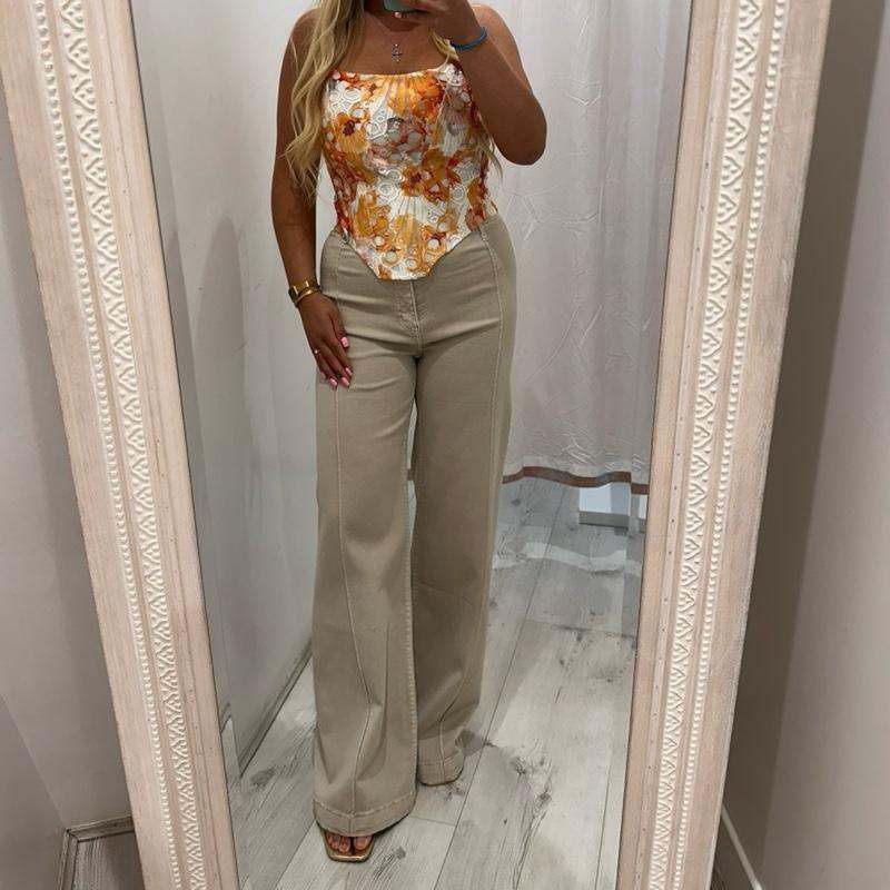 Pair of ADA beige stylish flared jeans displayed on a mannequin