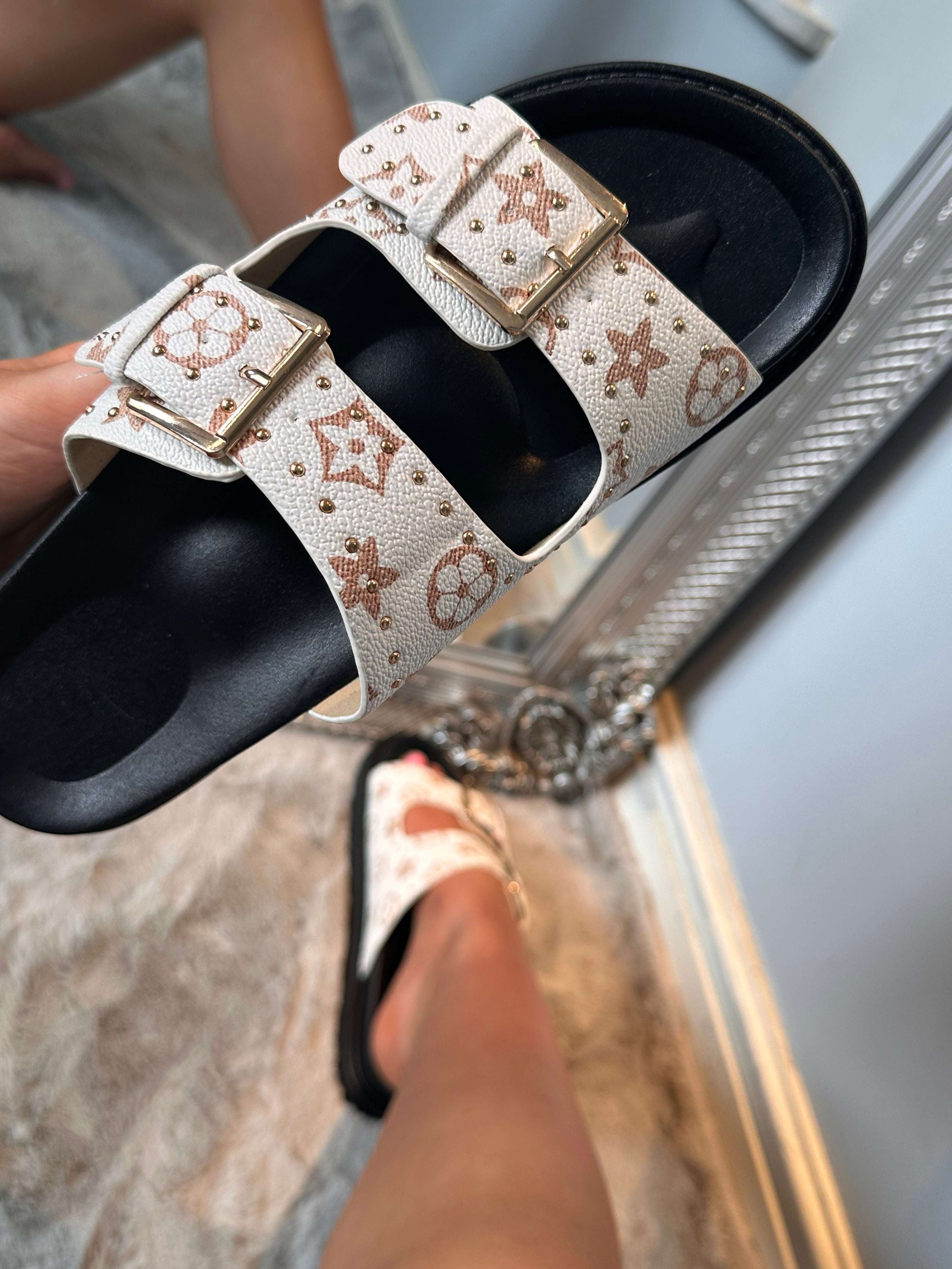 Close-up of ergonomic LOLA buckle detail sliders on footwear showing adjustable fit and comfort design