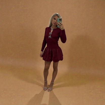 Women’s wine puff dress with bow detail and ruffled hem, stylish minimalist style.