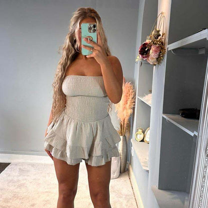 Woman wearing Lola Cheesecloth Summer mini playsuit with frilly bandeau top and shorts outdoors