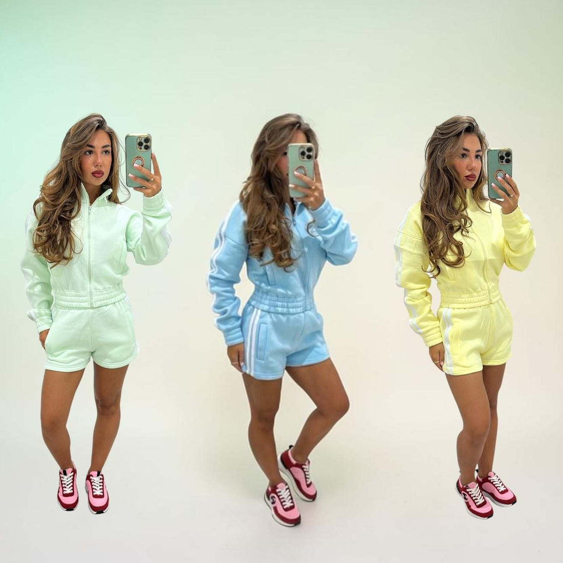 Woman wearing fleeced stripe detail short tracksuit set RIRI sitting on stairs outdoors