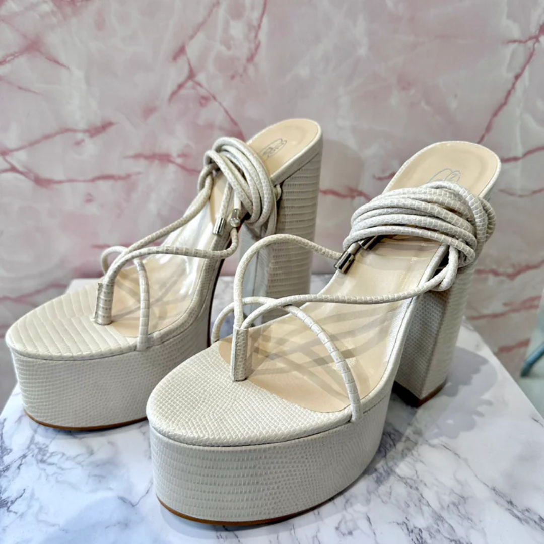 Cream lizard print platform heels with tie-up ankle straps and block heel, elegant women’s high heels on marble surface