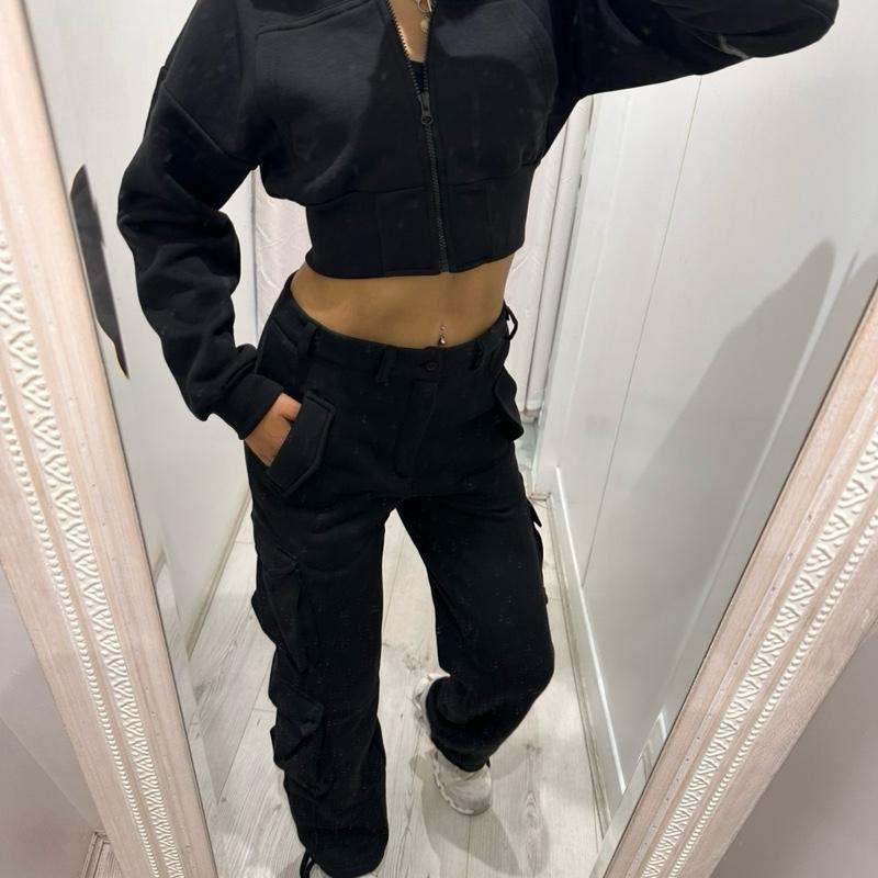 Woman wearing KADIE Zip Up Cropped Top and cargo trouser tracksuit in casual outdoor setting