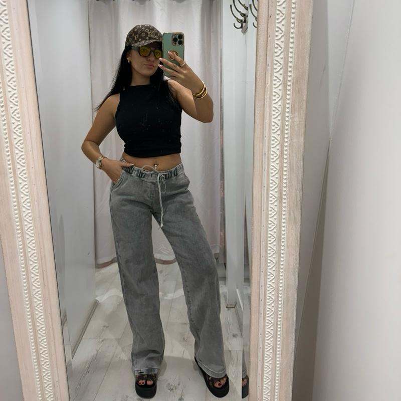 Grey NORA high-waisted wide-leg jeans with elasticated waistband and drawstring, styled casually